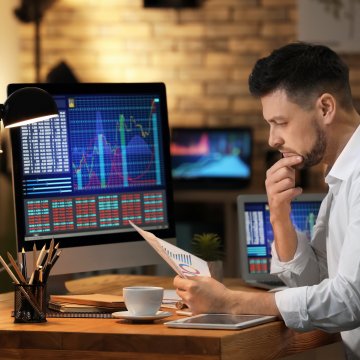 Guy sitting and looking at stock trades